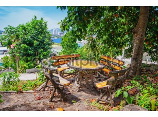 Фотообои «Wooden table and chairs in the garden on the terrace» - фото (1)